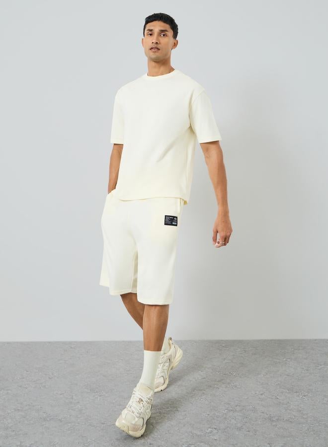 Styli Men Oversized Badge Detail T-Shirt and Shorts Co-Ords - Image 1